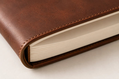 Close-up of thick blank sketchbook paper insert and leather cover edge