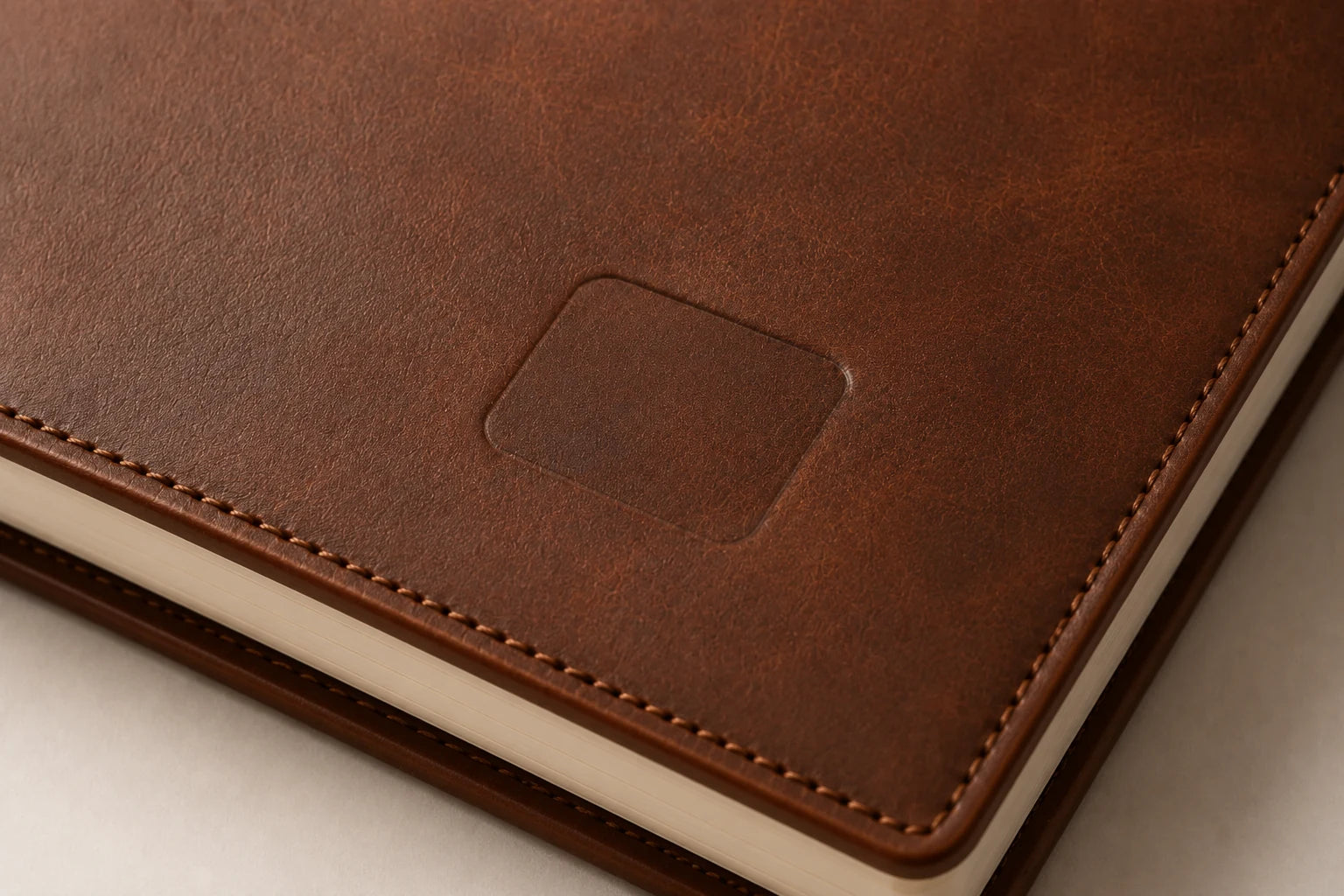 Blank logo debossing area on brown leather sketchbook cover