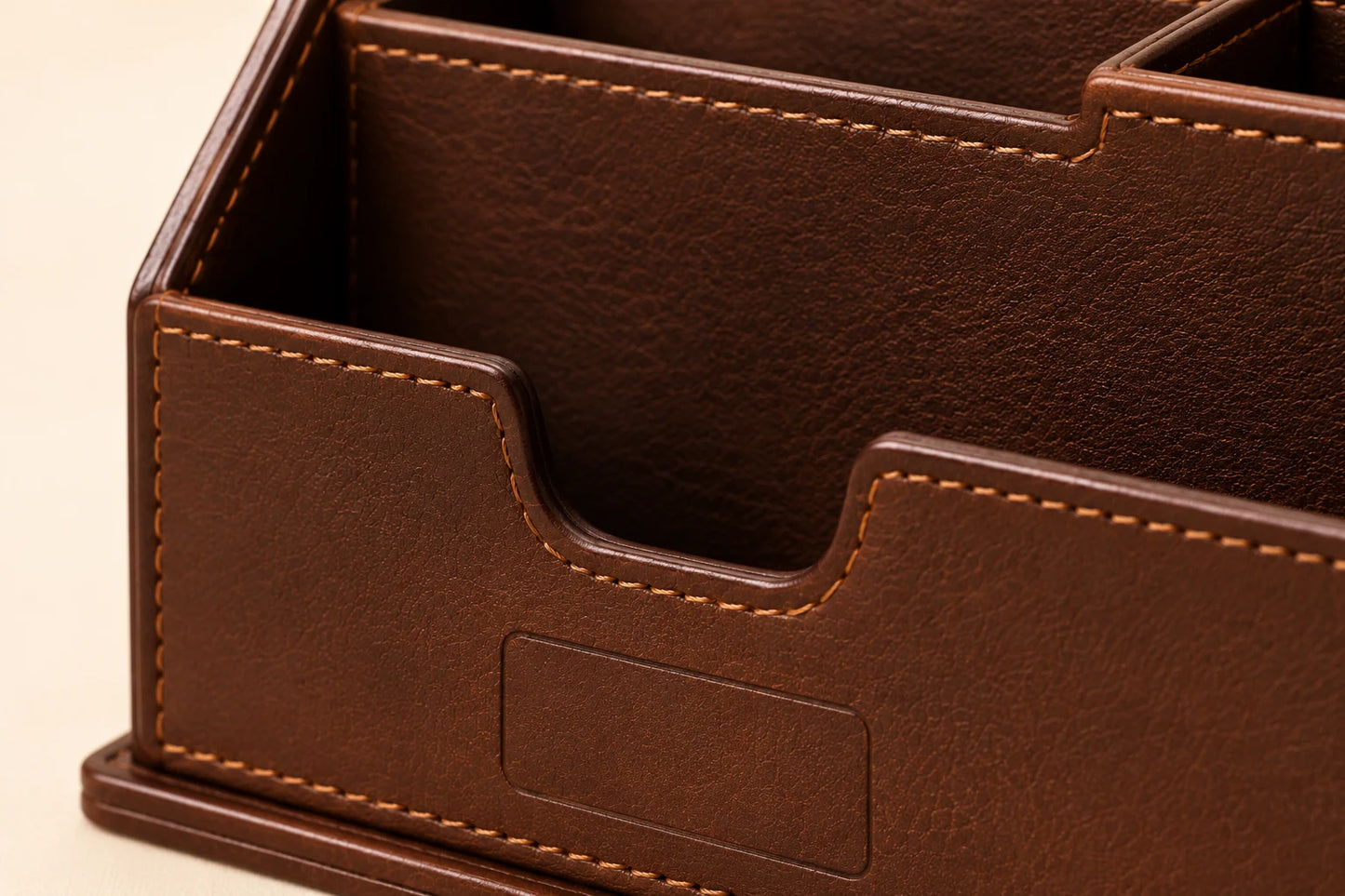Close-up of leather slot construction stitching and front blank logo area