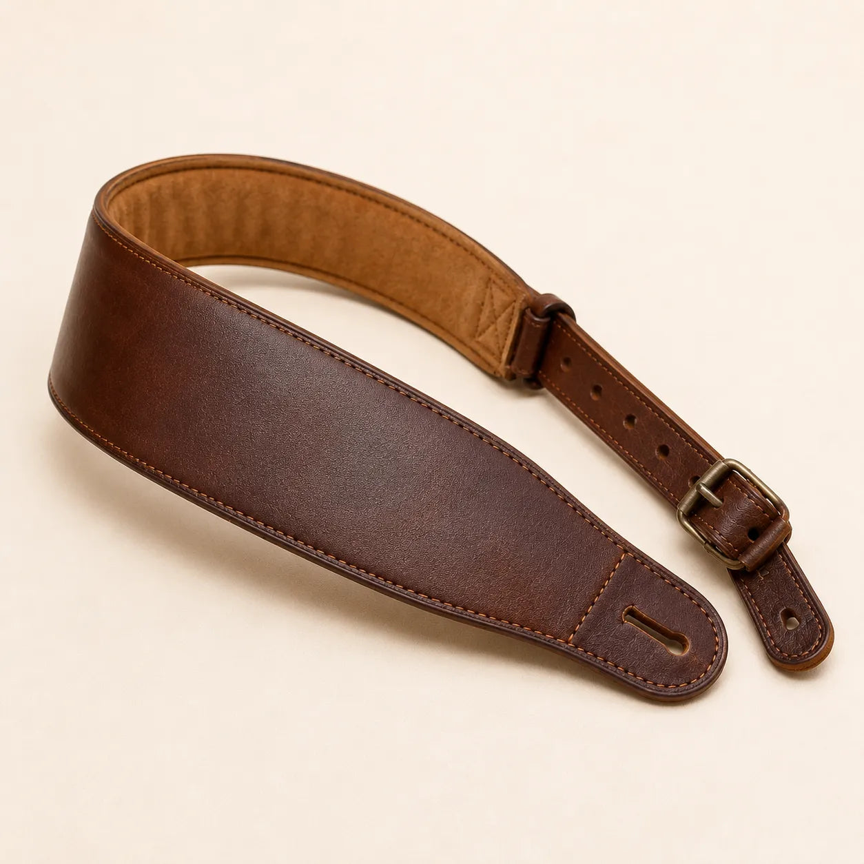 Angled view of padded leather guitar strap with soft inner lining