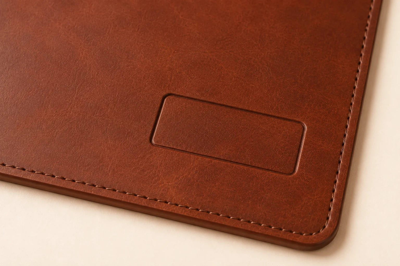 Close-up of blank logo area and leather grain on personalized desk mat