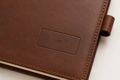 Blank logo debossing area on brown leather notebook cover