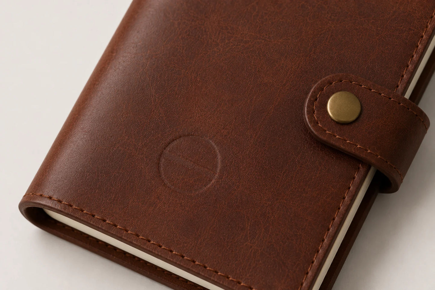 Blank logo debossing area on compact brown leather notebook cover