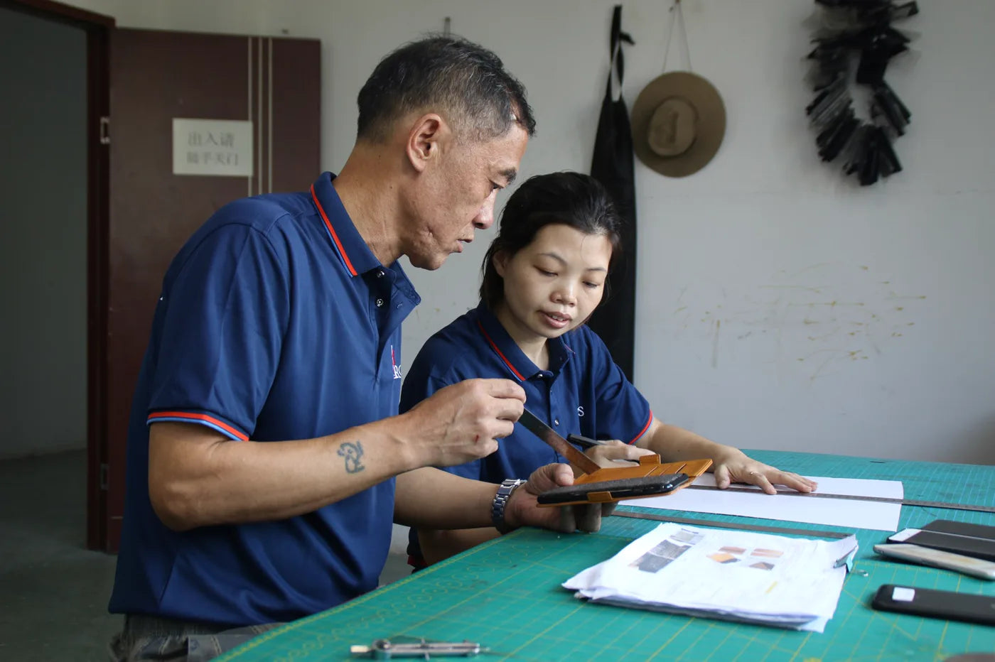 Aarons Leather team reviewing leather sample construction